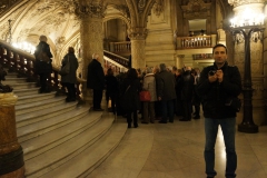Near a group of tourists, inside Garnier Opera House, Paris, France
